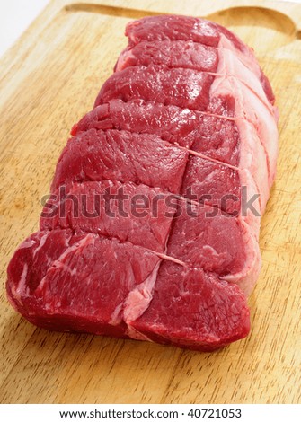 Fresh Raw Beef Steak Roast On A Wooden Butchers Block Cutting Board