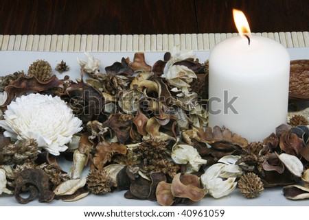 Decorative plate with dried flowers and burning candle - home decoration concept