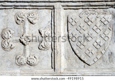 Detail of the Basilica of Santa Maria Novella - famous landmark of Florence, Italy. Cross and shield