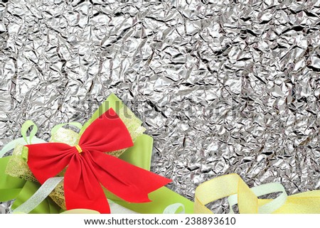 Shiny  Bronze leaf and  ribbon on Shiny foil texture background