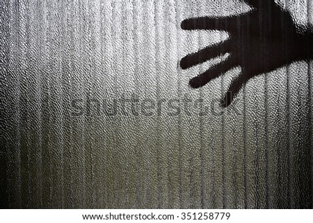 Silhouette of a hand the expression to be imprisoned, blur