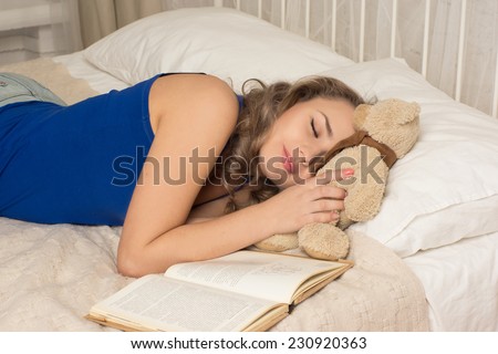 Woman sleeping on the bed/Woman sleeping on the bed with a book and a teddy bear