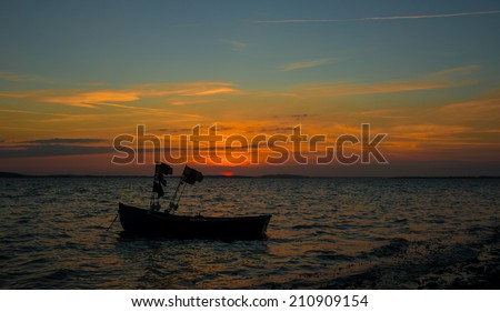 Sailing at sunset in front of the Oland bridge in the Baltic sea, Sweden.