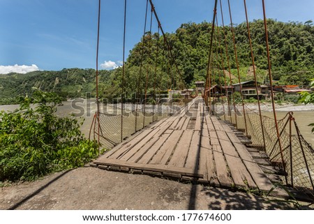 Hangin bridge over a river in the peruvian jungle