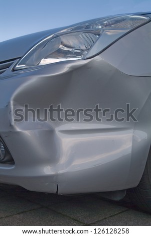 A dent in the right front quarter of a european car