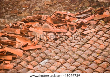 Red clay shingles roof after storm