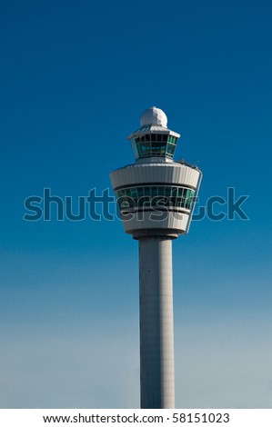 Airport tower at Schiphol airport in the Netherlands against blue sky