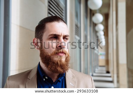 Bearded hipster wearing shirt and jacket in the city outdoor