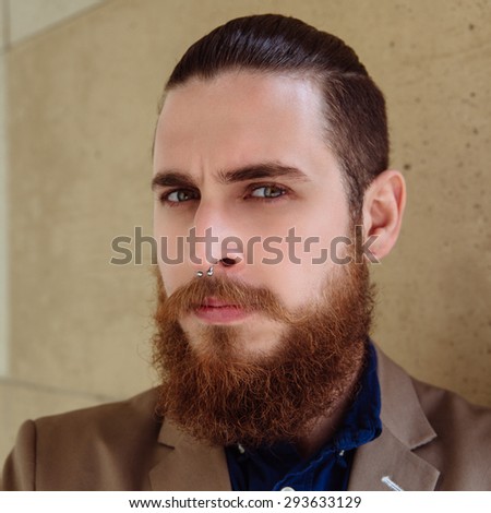 Bearded hipster wearing shirt and jacket in the city outdoor