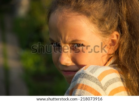 Closeup portrait of Scared and angry cute little girl. Domestic violence concept.