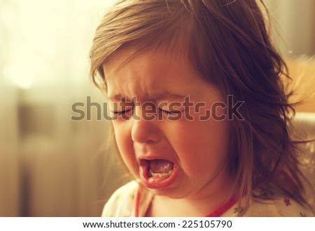 cute little kid is crying
