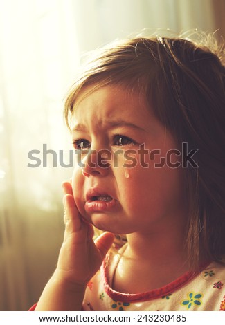 Cute little girl is crying. Toned