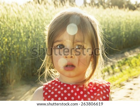 Pretty Little girl thinking at sunset