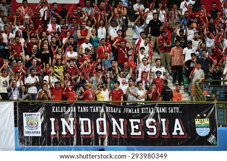 KALLANG,SINGAPORE-JUNE11:Unidentified fan of Indonisia national supporters during 28th SEA Games Singapore 2015 match between Indonisia and Singapore at JalanBesar Stadium on JUNE11 2015 in,SINGAPORE.