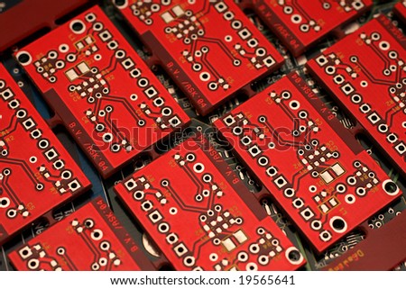 Red circuit board without components.