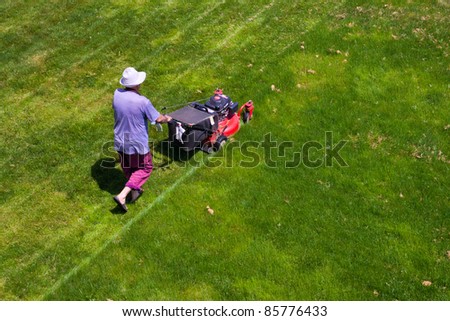 male gardener working with lawn mower