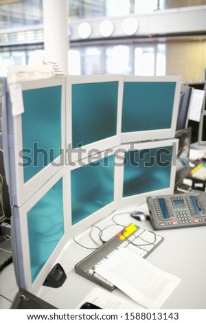 Work station with many computer monitors in office
