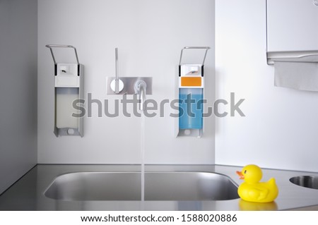 Sink in medical facility with toy rubber duck on counter