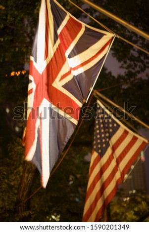 American and British flags illuminated at night