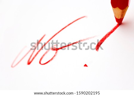 Red pencil writing No with an exclamation point