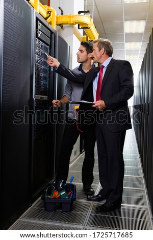 Computer technician and businessman in server room in Cape Town, South Africa