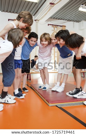 Young schoolboys in gym having a huddle