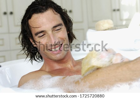 Man washing in bubble bath