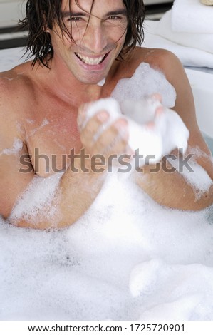 Man laughing in bubble bath
