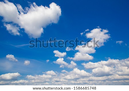 Blue sky with white rolling clouds