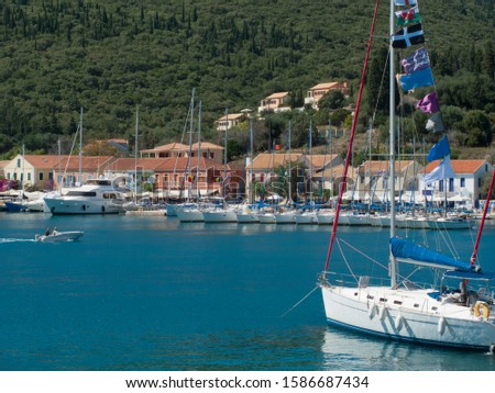 Greece, Kefalonia, Fiskardo, view of yachts and sunny coastal harbour