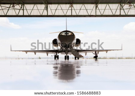 Pilot checking wing of private jet