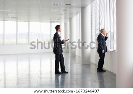 A letting agent showing a businessman around an empty office