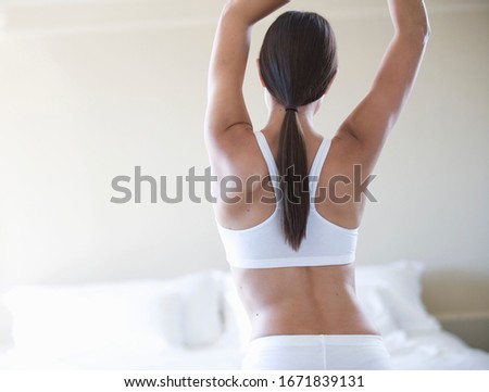 A young woman stretching arms