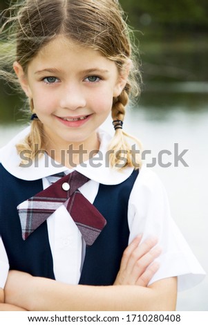 Portrait of a schoolgirl in pig tails
