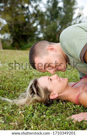 Two young lovers kissing outdoors