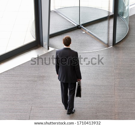 Birds eye view of businessman leaving office