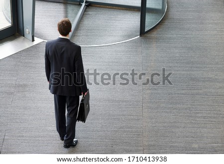 Birds eye view of businessman leaving office