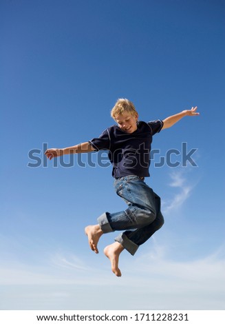 A young boy jumping in the air with excitement