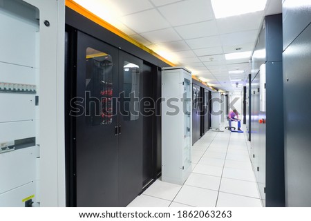 Wide shot of a data center with server cabinets