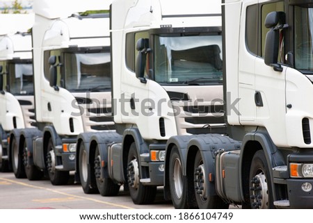 Freight transportation trucks parked in a row
