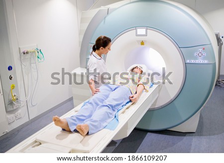A nurse and a patient starting the MRI scan in the hospital