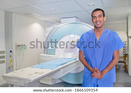 Portrait of a confident technician nurse standing next to the MRI scanner in the hospital