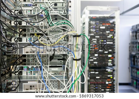 Complex array of wires at the back of a server cabinet.