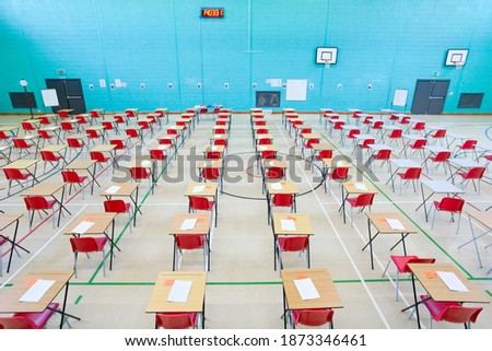 Desks arranged in a wide exam hall