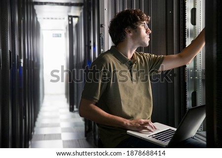 Technician working with a laptop in the secure data center