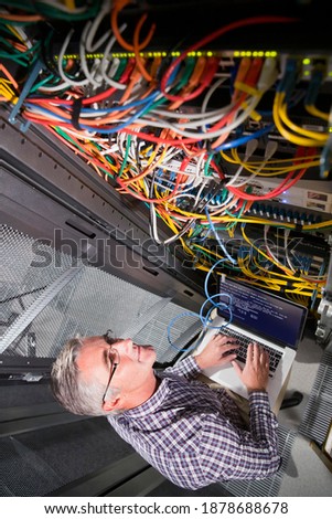 Technician working on a Laptop in the secured data center