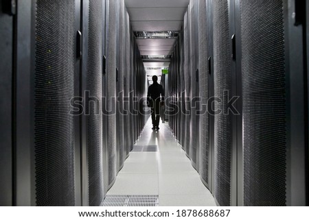 Silhouette Of a Technician Walking Between the Servers In the Data Centre