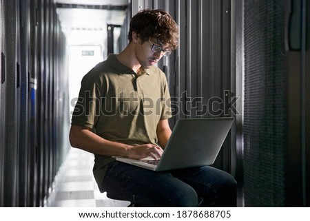 Technician working on a laptop in the secured data center
