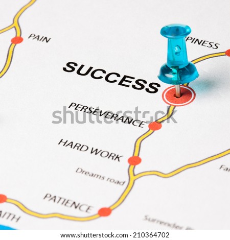 Success as target in the dreams road. Conceptual image where the cities are the principles that lead to the success target. Selective focus on the thumbtack.