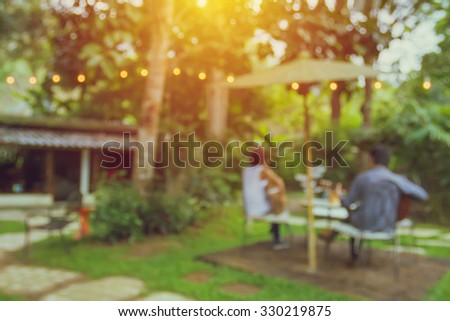 blurred cafe to sit and enjoy a eat and drink in the evening a surrounded by nature for background. vintage style photo